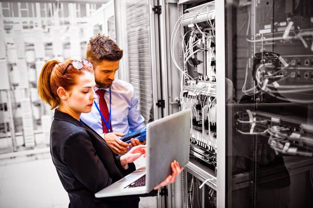 technicians-using-laptop-while-analyzing-server-2023-11-27-04-56-46-utc_11zon